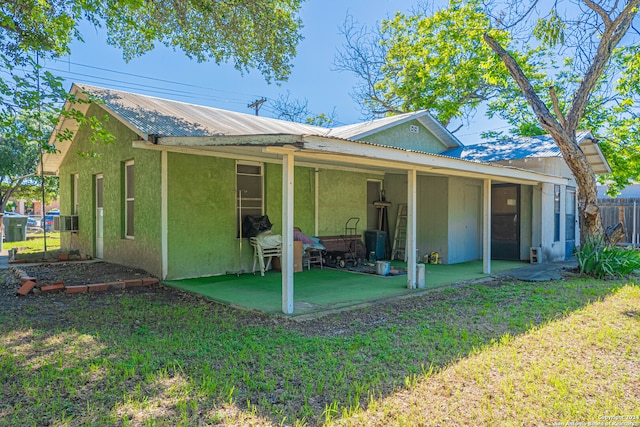 back of house featuring a yard and a patio