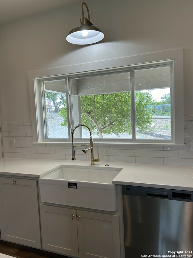 kitchen featuring white cabinetry, dishwasher, sink, and tasteful backsplash