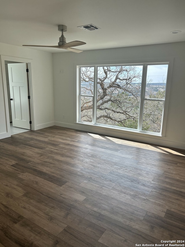 spare room with ceiling fan and dark hardwood / wood-style floors