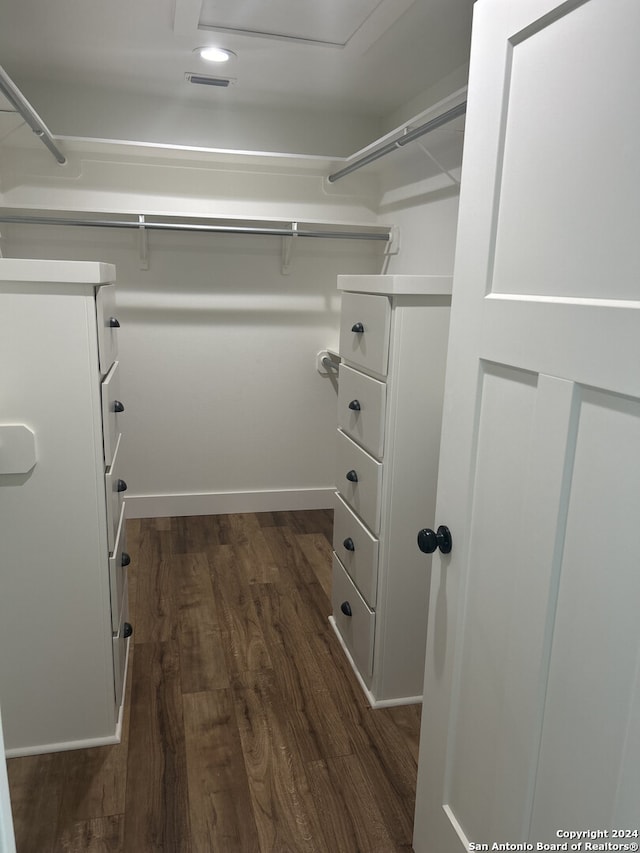 spacious closet with dark hardwood / wood-style floors