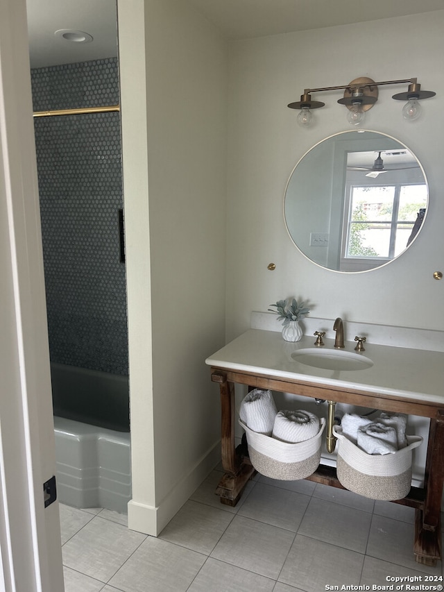 bathroom featuring tiled shower / bath, vanity, and tile patterned flooring