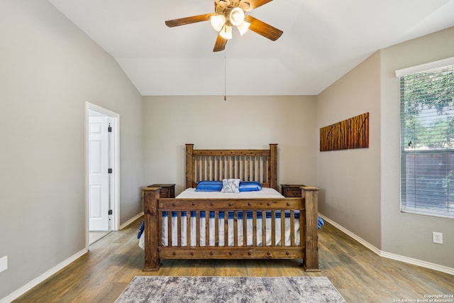 bedroom featuring ceiling fan, lofted ceiling, and dark wood-type flooring