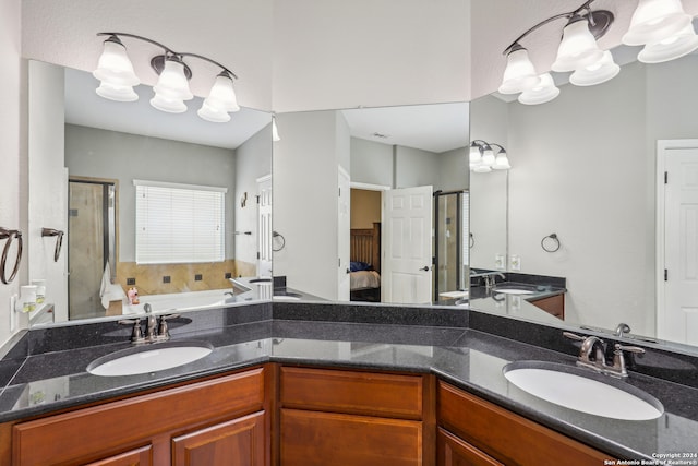 bathroom with shower with separate bathtub, vanity, and an inviting chandelier