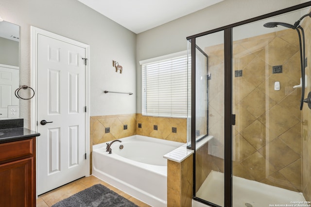 bathroom with tile patterned floors, independent shower and bath, and vanity