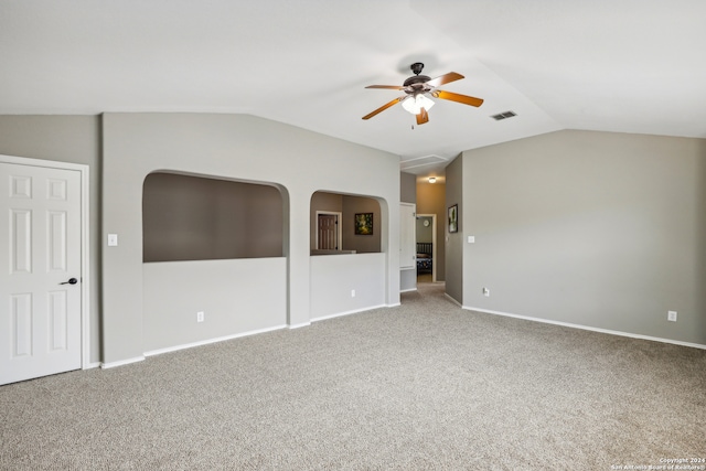 carpeted spare room with ceiling fan and vaulted ceiling