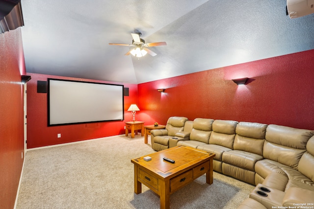 carpeted cinema with a textured ceiling, vaulted ceiling, and ceiling fan