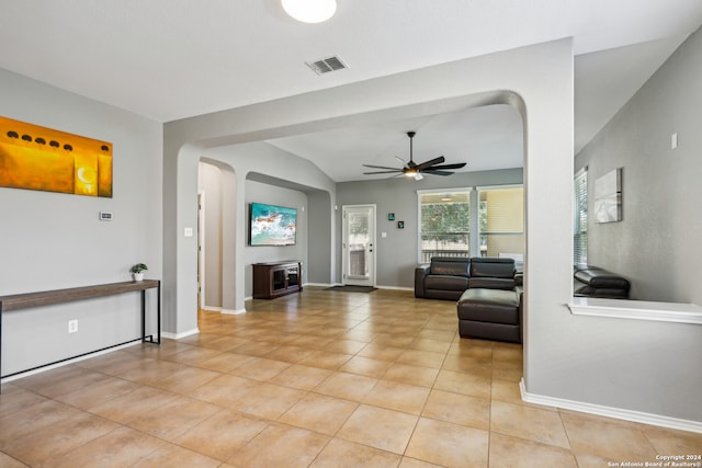 living room with ceiling fan and vaulted ceiling