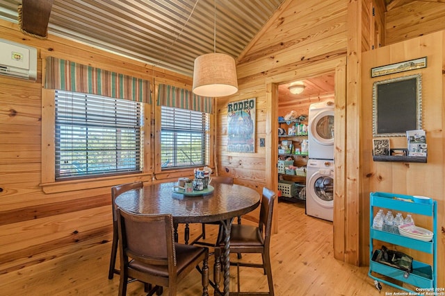 117 Hawk Rd, Fredericksburg, TX 78624 - dining room with lofted ceiling, wood walls, wood finished floors, and stacked washer and dryer