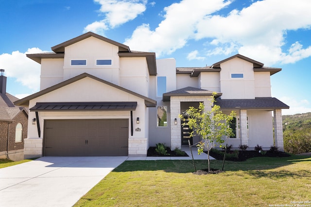 view of front of home featuring a garage and a front lawn