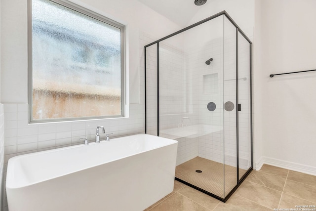 bathroom with shower with separate bathtub and tile patterned floors