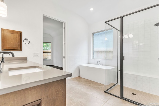 bathroom featuring separate shower and tub, tile patterned flooring, vanity, and lofted ceiling