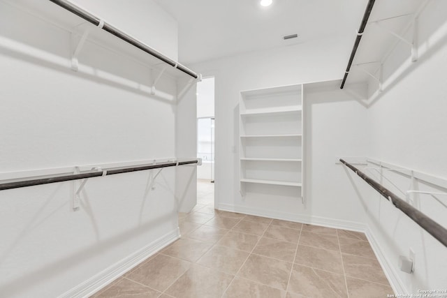 spacious closet featuring light tile patterned flooring