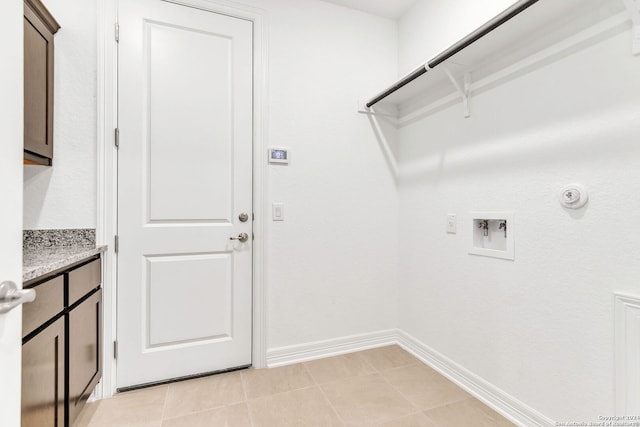 clothes washing area featuring hookup for a gas dryer, hookup for a washing machine, and light tile patterned floors