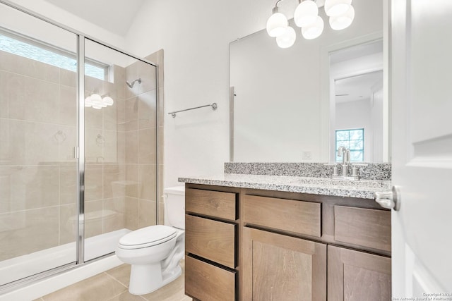 bathroom with tile patterned floors, vanity, toilet, and an enclosed shower