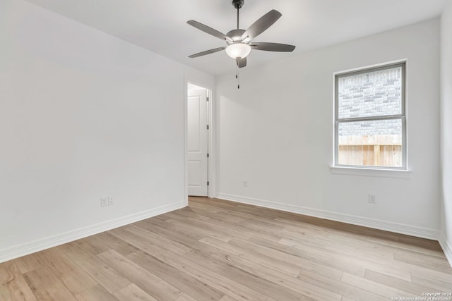 empty room featuring light wood-type flooring and ceiling fan