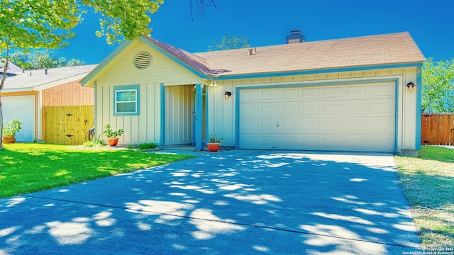 ranch-style home featuring a front yard and a garage