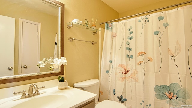 bathroom featuring vanity, toilet, and curtained shower