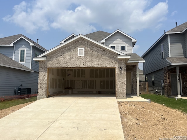 view of front of house featuring a garage and central AC unit