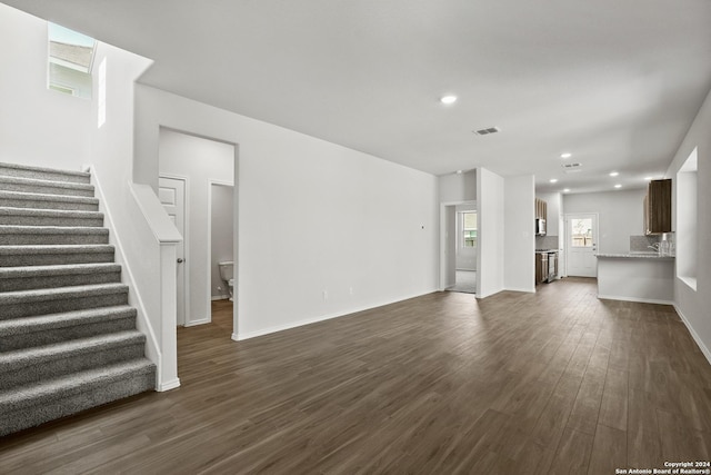 5103 Sandstone Way, San Antonio, TX 78222 - unfurnished living room featuring stairway, dark wood-type flooring, and recessed lighting