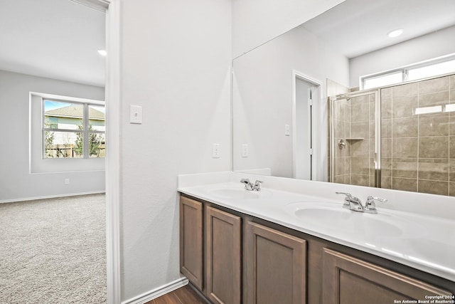 5103 Sandstone Way, San Antonio, TX 78222 - bathroom with plenty of natural light, a shower stall, and double vanity