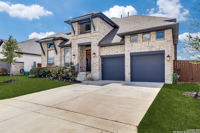 view of front of home with a front lawn and a garage