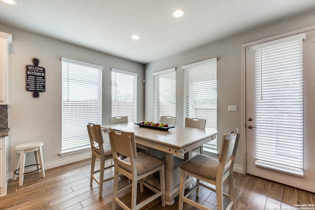 dining space featuring a textured ceiling and hardwood / wood-style flooring