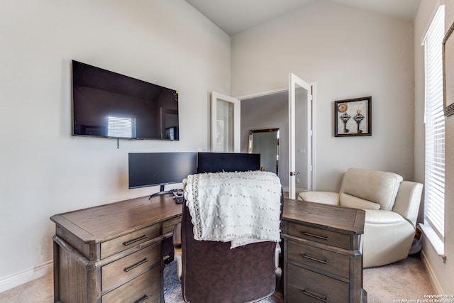 carpeted home office with vaulted ceiling