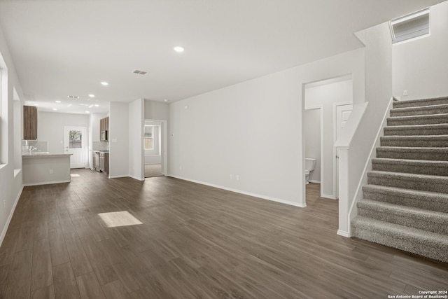 4951 Sandstone Way, San Antonio, TX 78222 - unfurnished living room featuring dark wood-type flooring, stairs, and recessed lighting