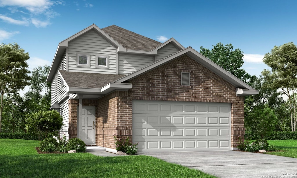 view of property with a garage and a front lawn