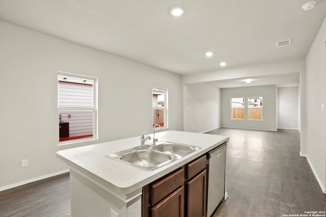 kitchen with stainless steel dishwasher, a kitchen island with sink, dark hardwood / wood-style flooring, and sink