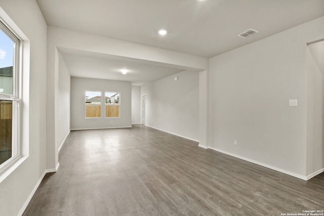 empty room with dark hardwood / wood-style flooring