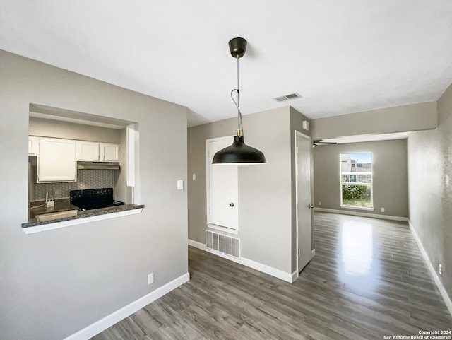 unfurnished dining area with dark hardwood / wood-style floors