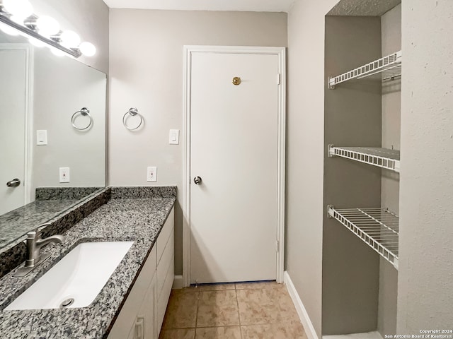 bathroom with tile patterned floors and vanity