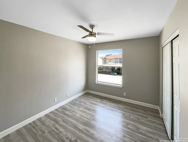 interior space featuring ceiling fan, hardwood / wood-style flooring, and a closet