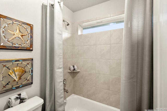 bathroom with toilet and shower / tub combo with curtain