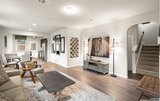 living room with dark hardwood / wood-style flooring