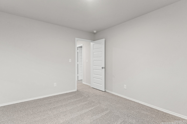 spare room featuring light colored carpet