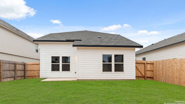 rear view of property with a lawn