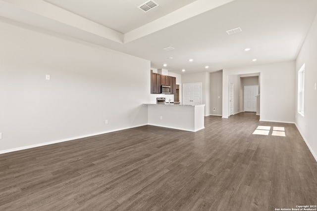 unfurnished living room featuring dark wood-type flooring