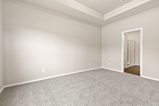 unfurnished room featuring dark carpet