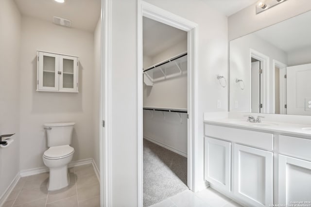 bathroom with tile patterned floors, vanity, and toilet