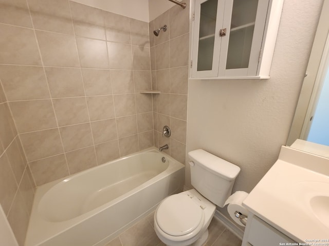 full bathroom featuring tiled shower / bath, vanity, and toilet