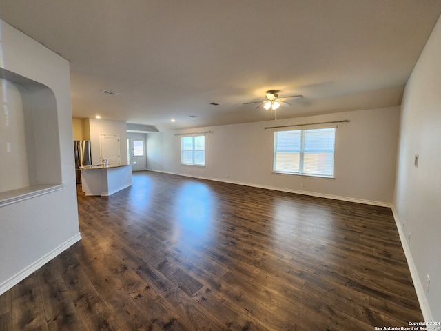 spare room with dark hardwood / wood-style floors and ceiling fan