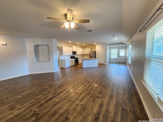 unfurnished living room with ceiling fan and dark wood-type flooring