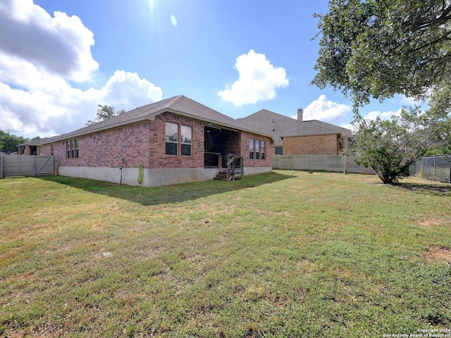 rear view of house with a lawn