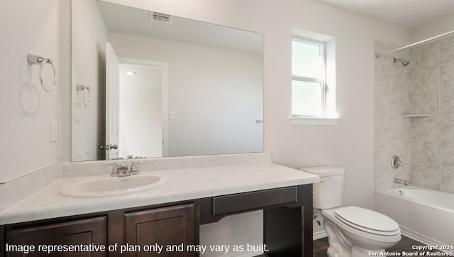 full bathroom with vanity, toilet, and tiled shower / bath