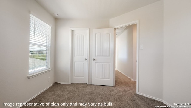 unfurnished bedroom with carpet floors and a closet