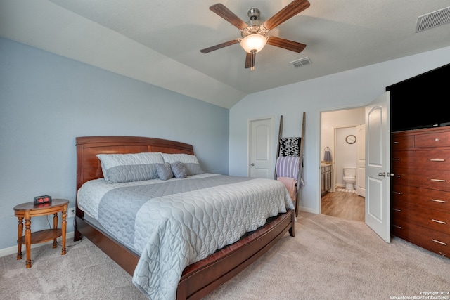 carpeted bedroom featuring vaulted ceiling, ceiling fan, and ensuite bathroom