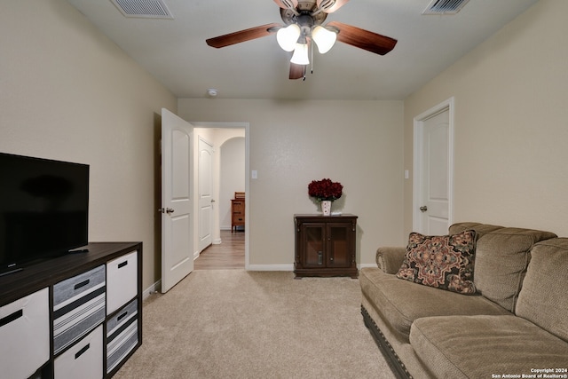 carpeted living room featuring ceiling fan