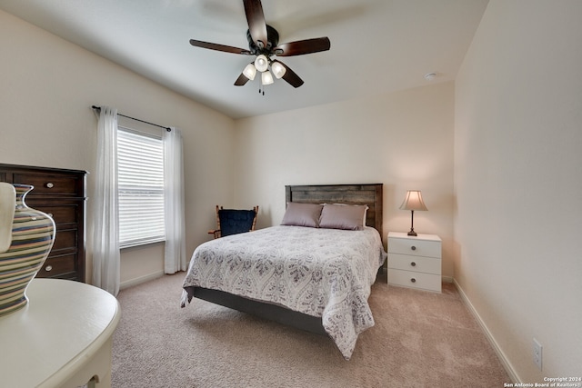 bedroom featuring ceiling fan and light colored carpet